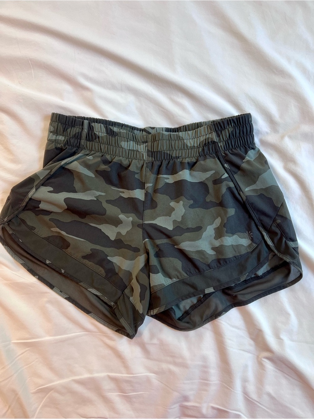 Athleta Printed Mesh Racer Run 4” Shorts in a green camouflage print